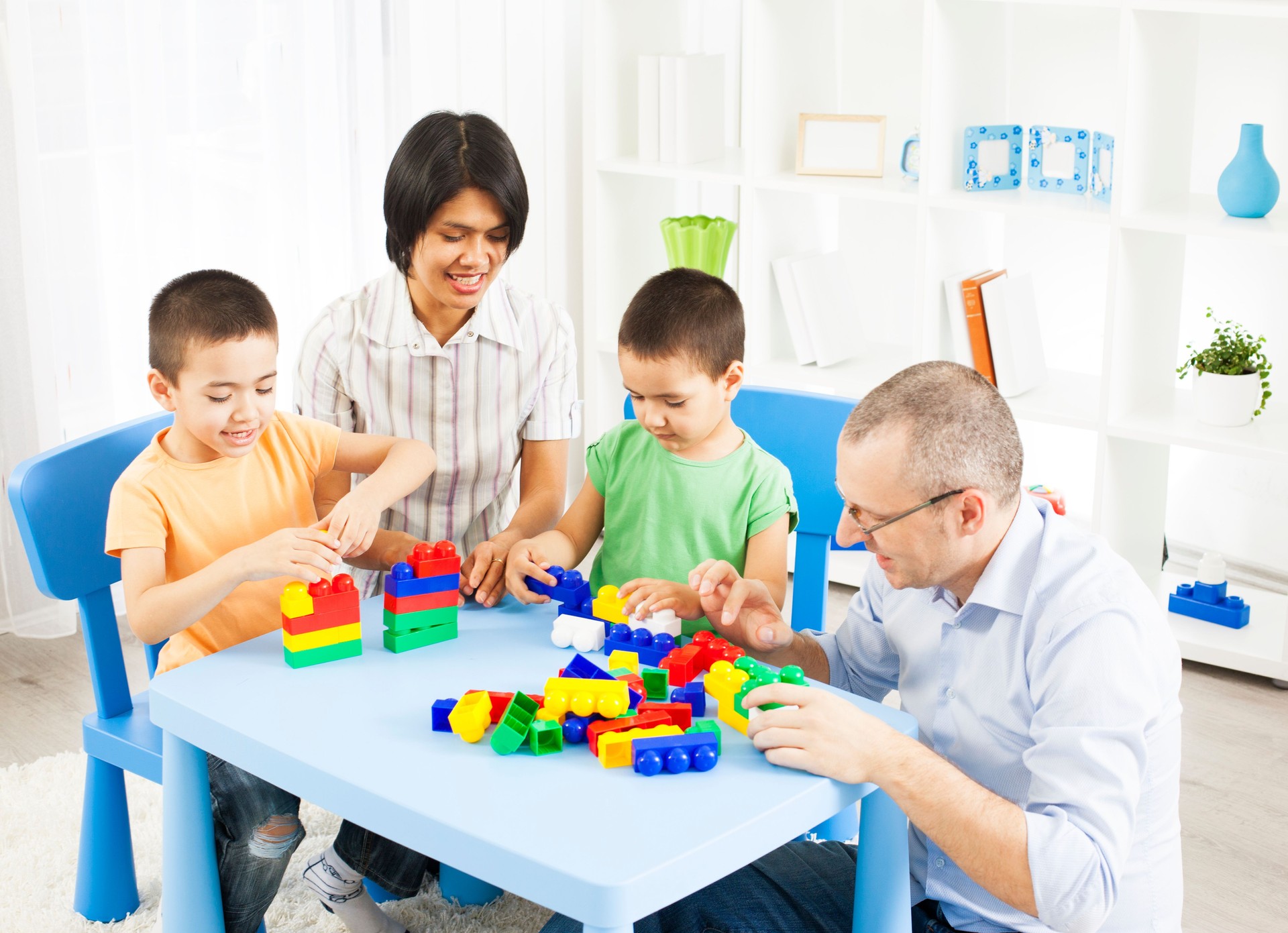 Mixed Race Family Playing with plastic blocks.